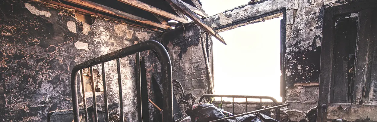 Photo of of a burned house by Acton Crawford on Unsplash